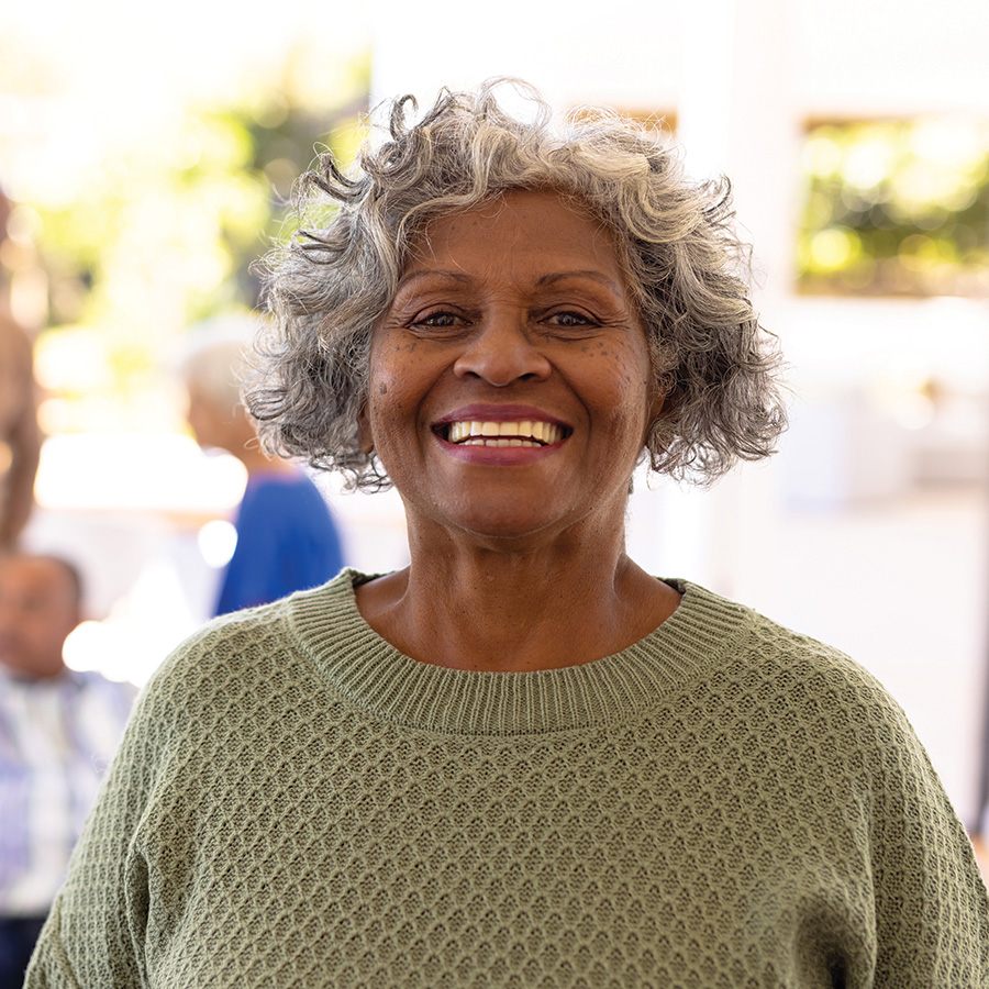 senior woman smiling with friends relaxing indoors 2026 03 25 00 51 41 utc