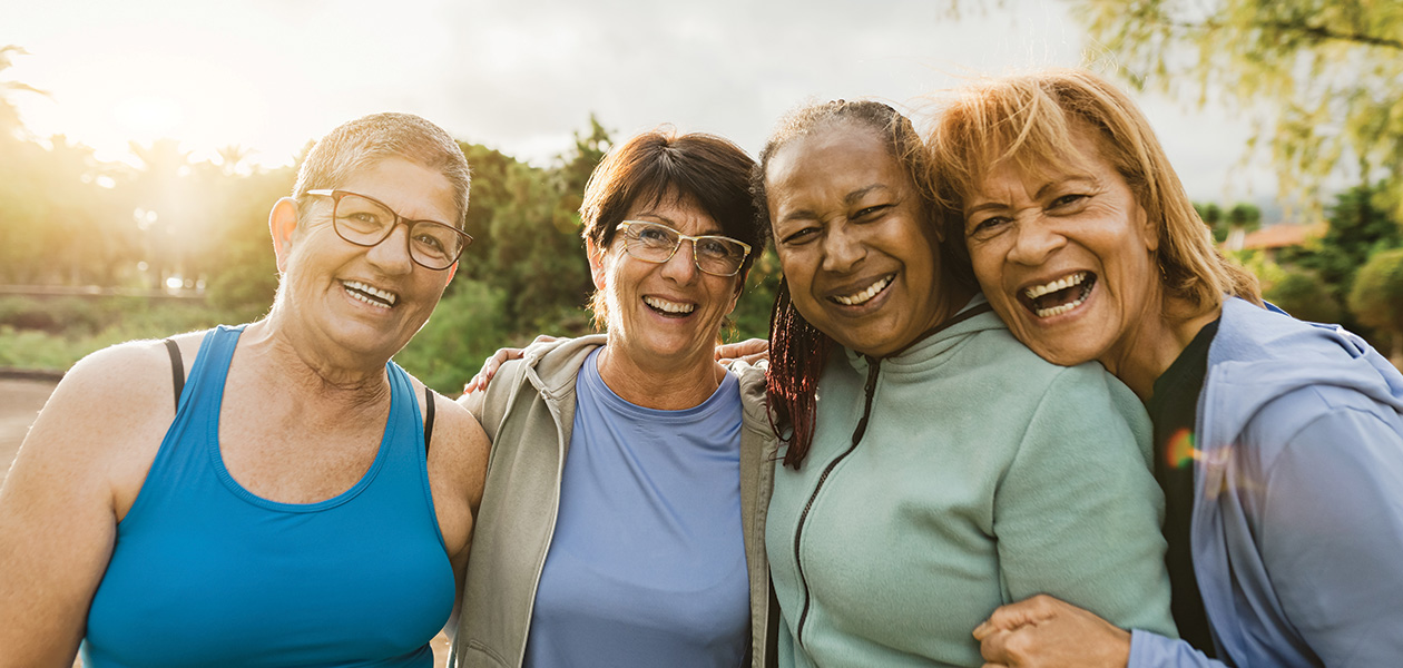 smiling women laughing and embracing outdoors in t 2026 01 06 09 41 38 utc