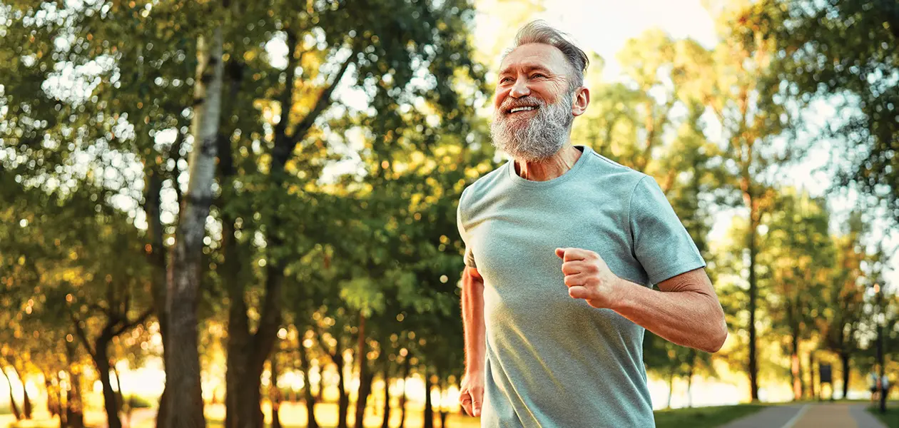 joyful senior man running in a green park 2026 01 09 06 22 28 utc