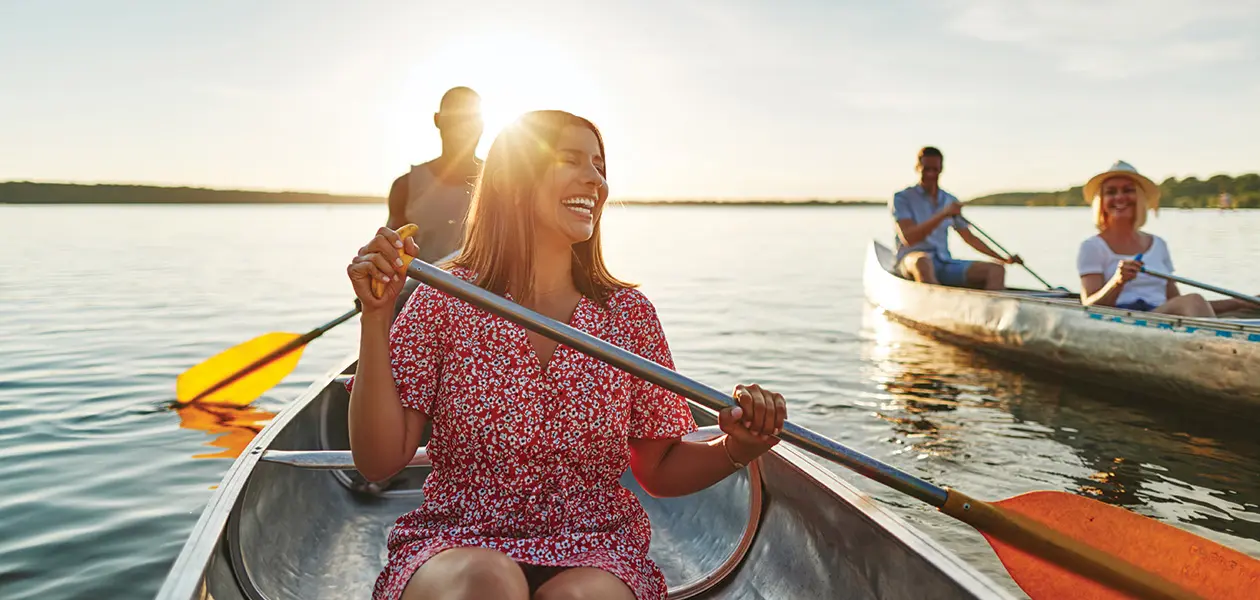 laughing woman canoeing with friends on a late sum 2022 02 02 04 52 21 utc