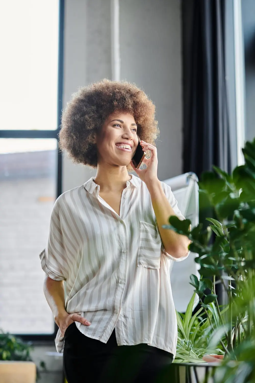smiling woman talking on phone in office setting 2026 01 06 00 21 31 utc (1)
